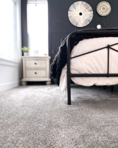 A newly installed gray carpet in a bedroom by Battleson's Flooring in Idaho Falls, ID.