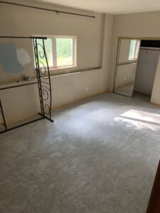 A bedroom with newly installed light gray carpet by Fairbanks Carpets Plus in Fairbanks, AK