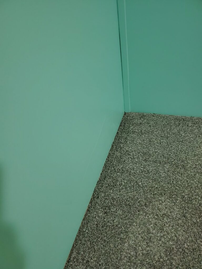 Newly installed gray carpet in a residential room, showcasing quality work by Prestige Flooring in Auburn, AL.