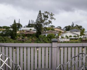 A modern gray composite fence installed on a deck overlooking a neighborhood by Redmond Valleywide - Hawaii's Fence Company in Kapolei, HI