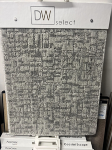 A close-up of a gray geometric pattern carpet sample at West Michigan Flooring & Interiors in Byron Center, MI.