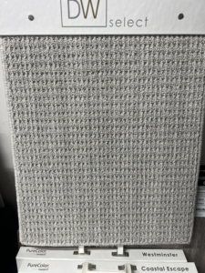 A close-up of a gray loop pile carpet sample at West Michigan Flooring & Interiors in Byron Center, MI.