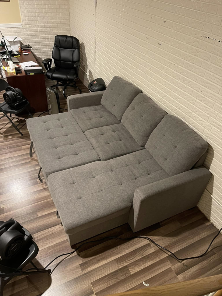 A gray sectional sofa undergoing upholstery cleaning and drying with fans by J&A Citrus-Carpet Tile Cleaning & Auto Detailing in Elkhart, IN.