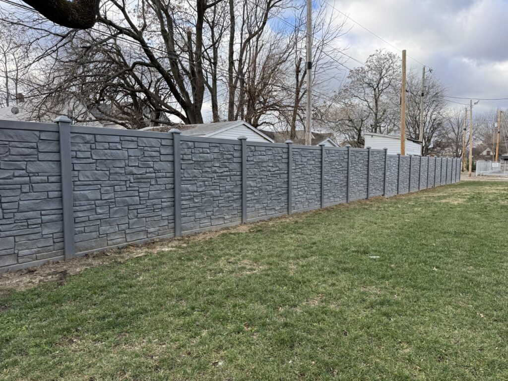 A unique gray stone-look privacy fence installed by ACE and Sons Fence Company in Evansville, IN.