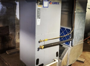 An indoor GREE furnace and air handler unit with connected ductwork, installed by Allied Heating and Air Conditioning in Port Richey, FL.