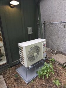 An outdoor Gree mini-split air conditioning unit installed by Cyber Heating and Cooling in Bloomington, MN.