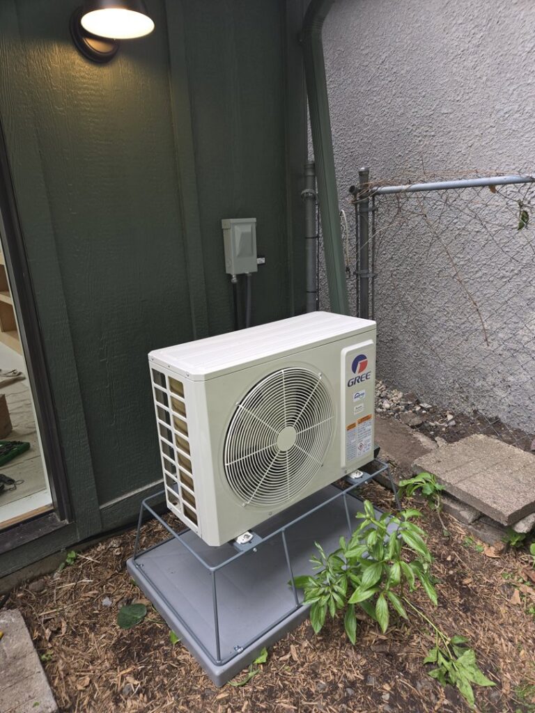 An outdoor Gree mini-split air conditioning unit installed by Cyber Heating and Cooling in Bloomington, MN.