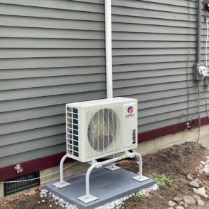 A Gree mini-split outdoor condenser unit installed on a raised stand by Revolution HVAC in Owings Mills, MD.