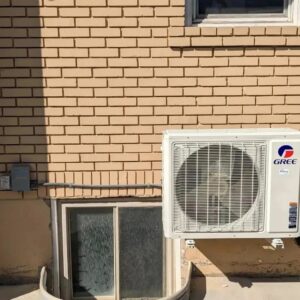 A wall-mounted Gree mini-split outdoor unit installed by Inspector Rogers LLC in Draper, UT.