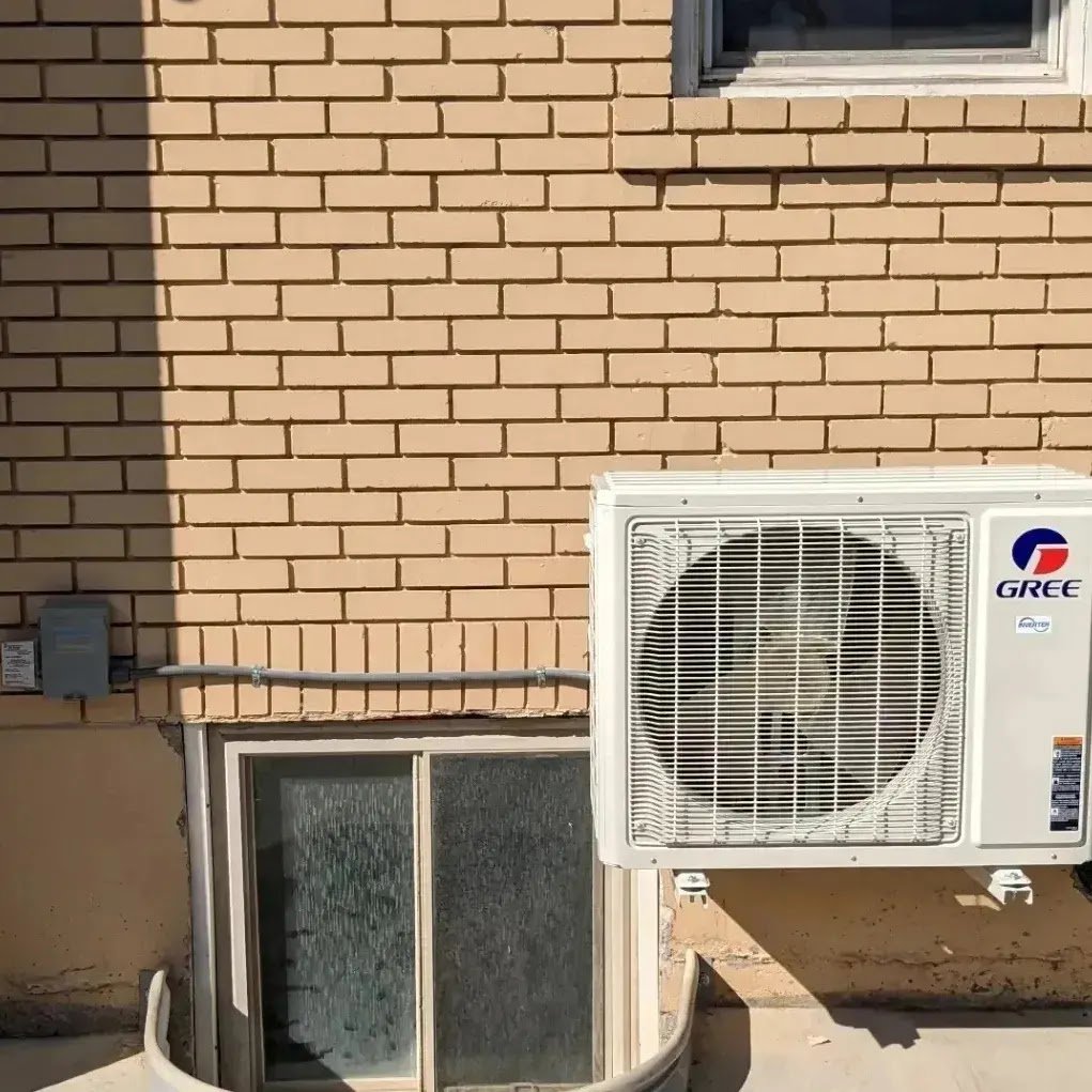A wall-mounted Gree mini-split outdoor unit installed by Inspector Rogers LLC in Draper, UT.