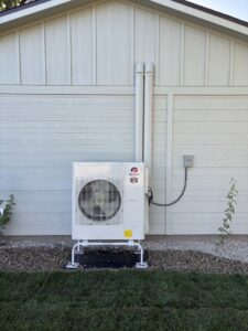 A Gree outdoor heat pump unit installed by Kingdom Heating and Air in Sacramento, CA.