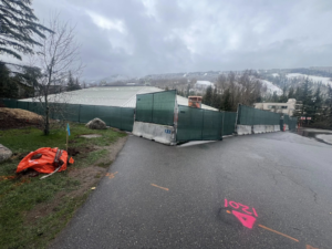 Green privacy screen fence with concrete barriers installed by Fence 4 Colorado in Thornton, CO.