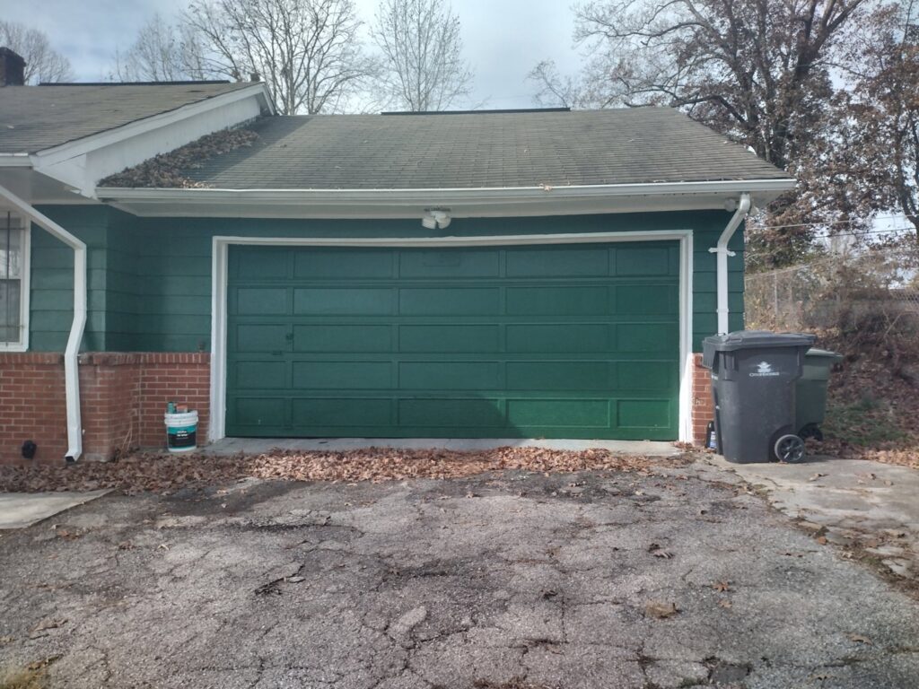 A vibrant green residential garage door, showcasing a completed installation by Knox Garage Door Service LLC in Knoxville, TN.