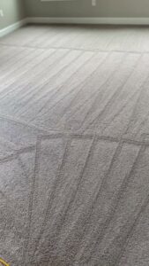 A grey carpet with visible cleaning stripes after professional service by Floor Medics in Huntsville, AL