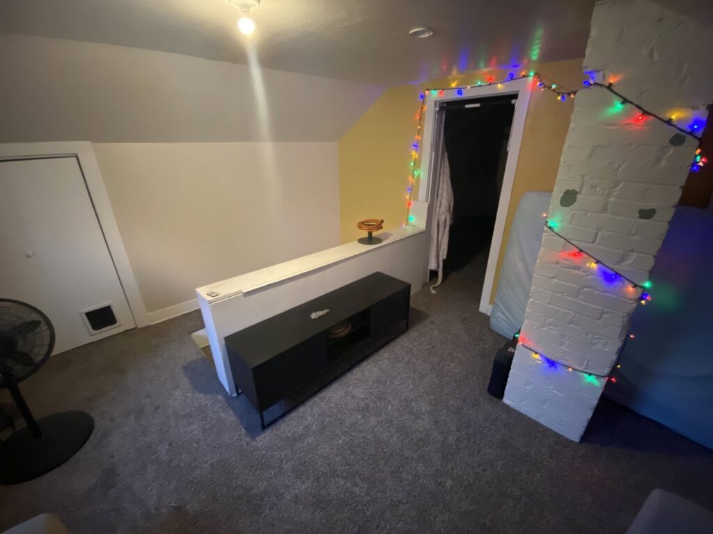 An attic room featuring a fresh grey carpet installation by Carpet Liquidators in Linthicum Heights, MD.
