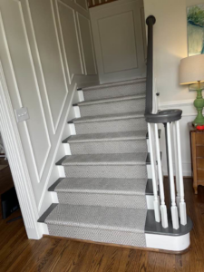 A stylish grey geometric patterned carpet runner installed on a staircase by Jimmy's Flooring in Louisville, KY