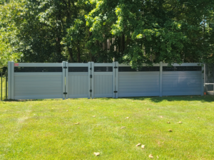 A section of modern grey horizontal fence featuring a gate, installed by AllMasterfence in Toms River, NJ.