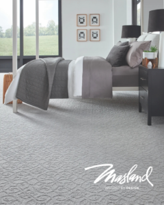 A modern bedroom featuring newly installed grey patterned carpet by Prosource of Savannah in Savannah, GA.