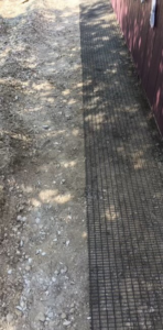 Ground mesh barrier installed for wildlife exclusion by Animal Management Systems Inc in Noblesville, IN.