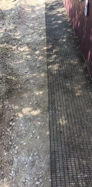 Ground mesh barrier installed for wildlife exclusion by Animal Management Systems Inc in Noblesville, IN.