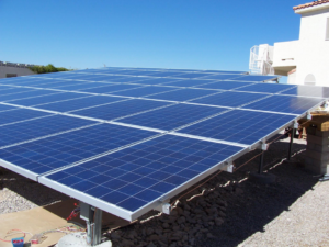 A large ground-mount solar panel installation by Arizona Best Solar in Surprise, AZ, showcasing electrical work.
