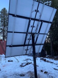 Underside of ground-mounted solar panels installed in a snowy landscape by J C Electric & Solar in Lewiston, ID
