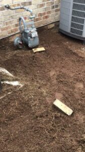 Ground preparation for a landscaping project next to a house by A & A Lawn Care Service LLC in Moore, OK.
