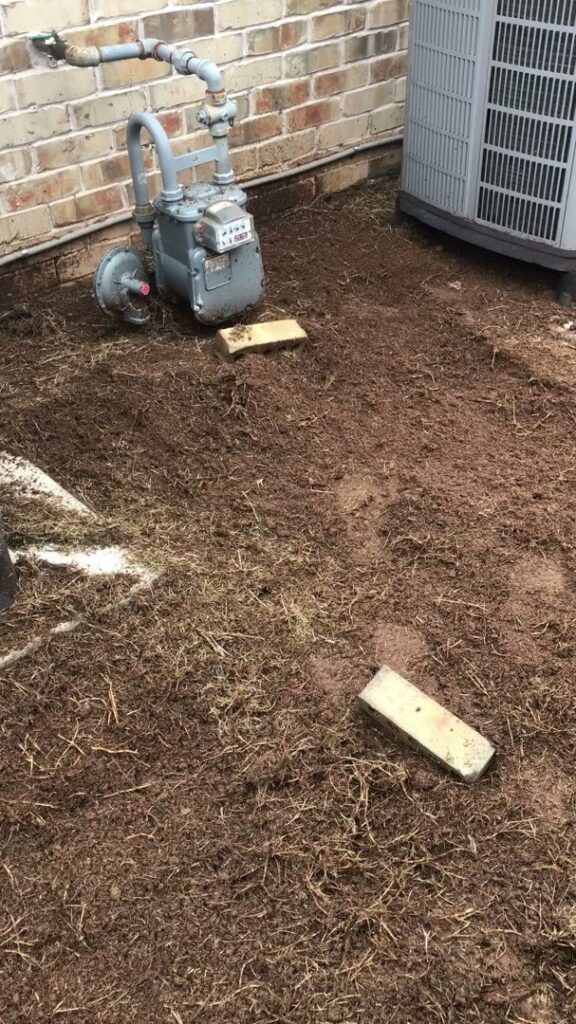 Ground preparation for a landscaping project next to a house by A & A Lawn Care Service LLC in Moore, OK.