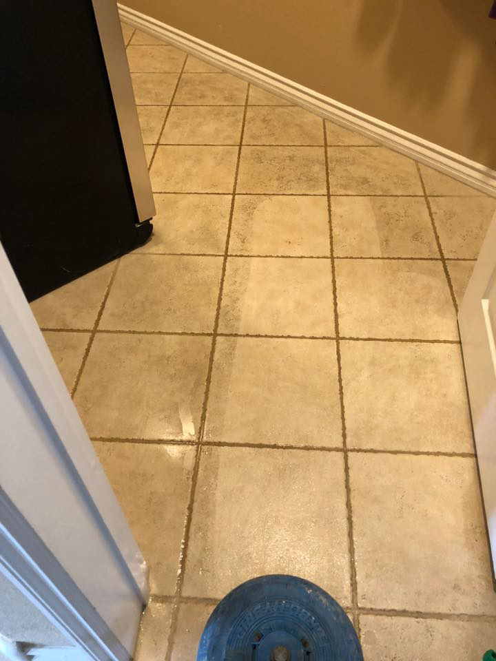 Grout cleaning in progress, showing a clean line on tile at Unlimited Carpet & Grout Cleaning in Las Vegas, NV.