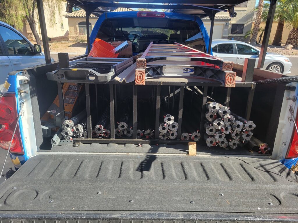 Gryffin Garage Door service truck loaded with ladders, tools, and garage door parts, ready for jobs in Chandler, AZ