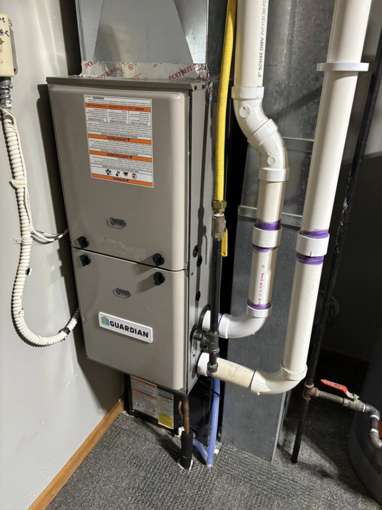 A newly installed Guardian brand furnace unit with associated piping by Fine Line HVAC LLC, serving homes in Isanti, MN.