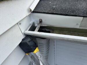 Close-up of a gutter with mesh exclusion being installed by D&K Pest Control and Wildlife Removal, LLC in Woodridge, IL
