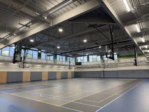 Newly installed overhead lighting in a gymnasium, completed by Cummings Electric in South Burlington, VT