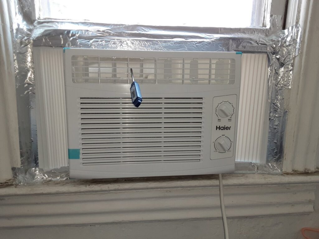 A Haier window AC unit installed, representing cooling services by Elements Heating & Cooling LLC in Minneapolis, MN.