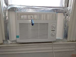 A Haier window AC unit installed, representing cooling services by Elements Heating & Cooling LLC in Minneapolis, MN.