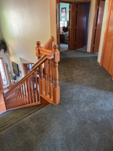 A view of a carpeted hallway and staircase, demonstrating carpet installation by Johnson Flooring in Newberg, OR.