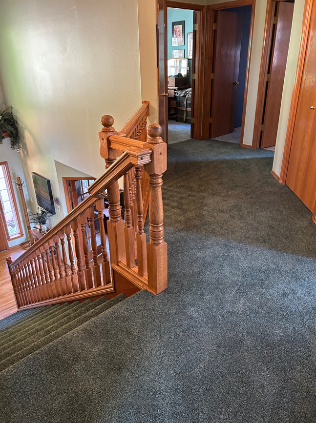 A view of a carpeted hallway and staircase, demonstrating carpet installation by Johnson Flooring in Newberg, OR.