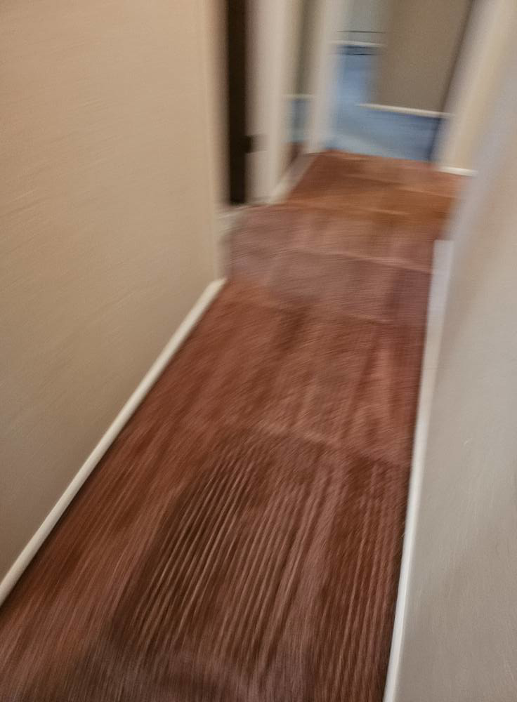 A freshly cleaned brown carpet in a hallway, showing professional cleaning lines by Super Clean Carpet Cleaning in Idaho Falls, ID.
