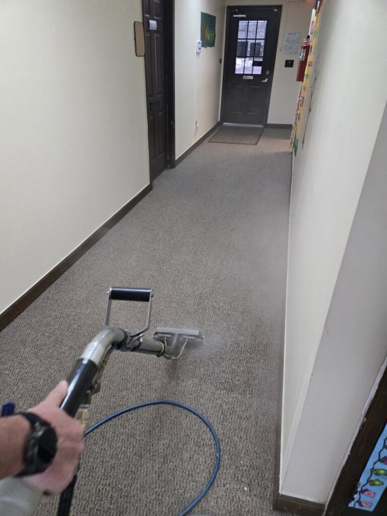 Hallway carpet cleaning in progress with a steaming wand by On The Spot Carpet and Upholstery Cleaning in Warren, MI.