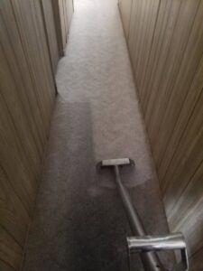 Hallway carpet cleaning in progress, showing a clean path by Regal Carpet Cleaning Inc. in Tucson, AZ