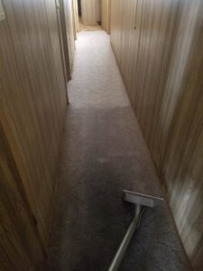 A long hallway carpet being cleaned with professional equipment by Regal Carpet Cleaning Inc. in Tucson, AZ