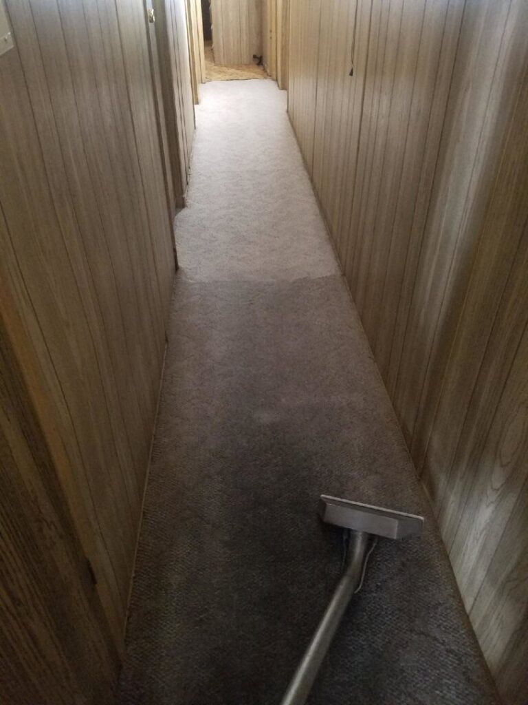 A long hallway carpet being cleaned with professional equipment by Regal Carpet Cleaning Inc. in Tucson, AZ