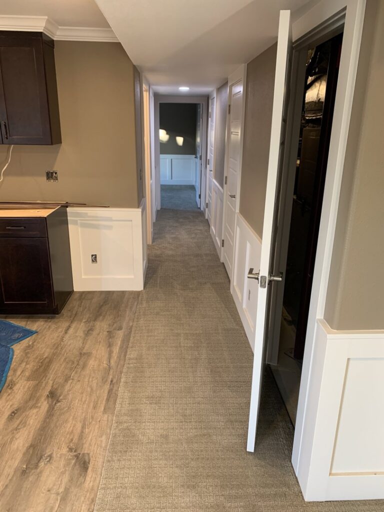 A newly carpeted hallway with light-colored wall-to-wall carpet by AguirreFloorz in Colorado Springs, CO.