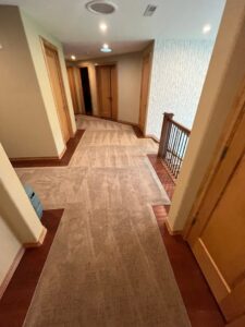A newly installed carpet in a residential hallway by Garrard's Flooring Service LLC, a carpet contractor in Cleveland, OH.