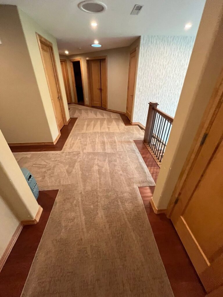 A newly installed carpet in a residential hallway by Garrard's Flooring Service LLC, a carpet contractor in Cleveland, OH.