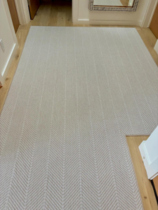 Long hallway carpet runner with a stylish herringbone design installed by Trademark Flooring in West Jordan, UT.