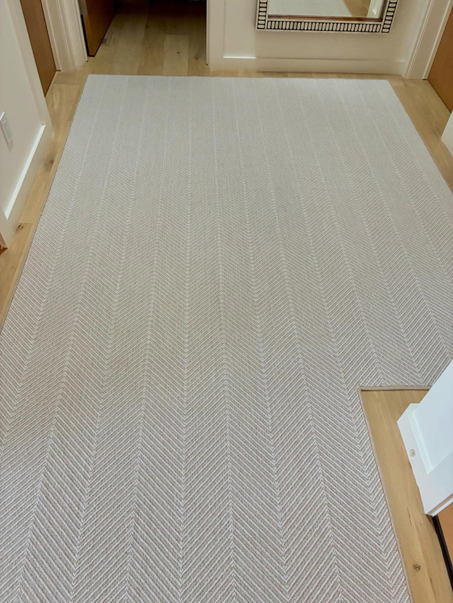 Long hallway carpet runner with a stylish herringbone design installed by Trademark Flooring in West Jordan, UT.