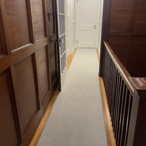 A newly installed carpet runner in a hallway by J MIKE PONTE FLOOR COVERING in Lowell, MA.