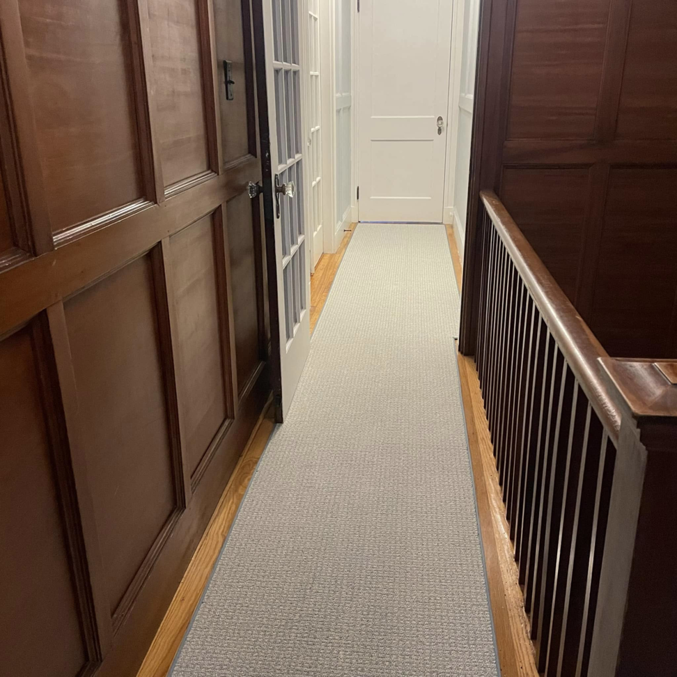 A newly installed carpet runner in a hallway by J MIKE PONTE FLOOR COVERING in Lowell, MA.