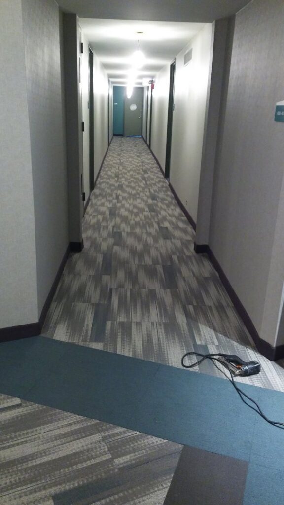 Hallway with installed carpet tiles and a blue carpet runner by Chicago Floor Systems in Chicago, IL